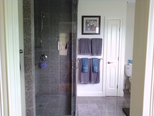 Bathroom with granite tile walk-in shower and glass door