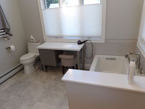 Master bath remodel with freestanding soaking tub, makeup vanity, and tile floor