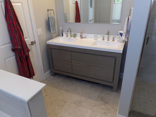 Master bath with gray double vanity, white quartz countertop, and tile floor