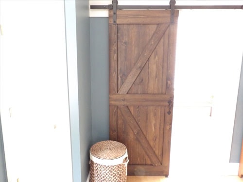 Custom barn door with rustic wood finish and black hardware
