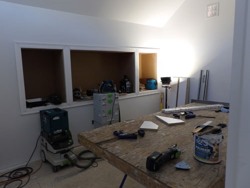 Interior finish work with custom built-in wall niches, drywall, and primer coat