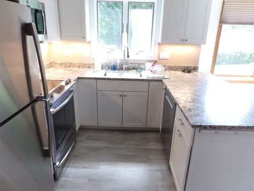 Custom kitchen with white cabinets and granite countertops