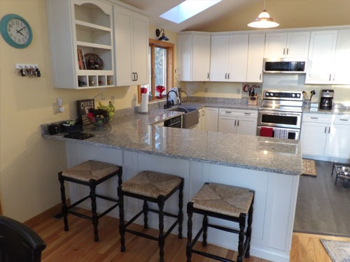Open kitchen with peninsula seating and skylight