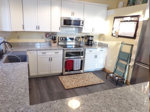White kitchen remodel with dark hardwood floors
