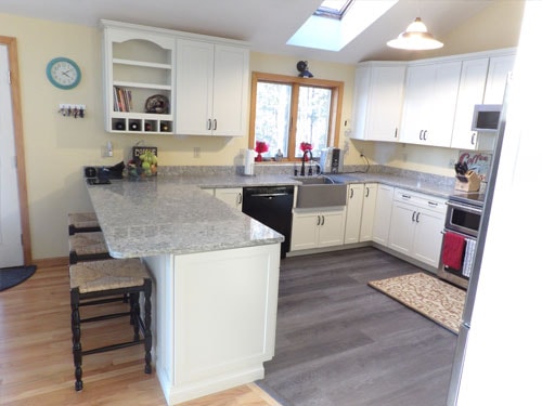 Kitchen with peninsula, skylight, and farmhouse sink