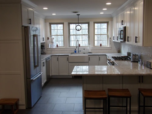Completed kitchen remodel with slate tile floor and farmhouse sink