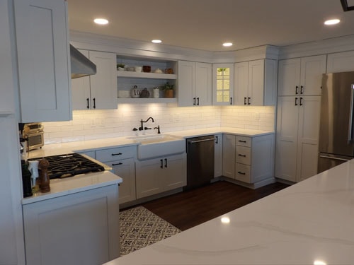 Wide kitchen remodel with large marble island and dual cabinet zones