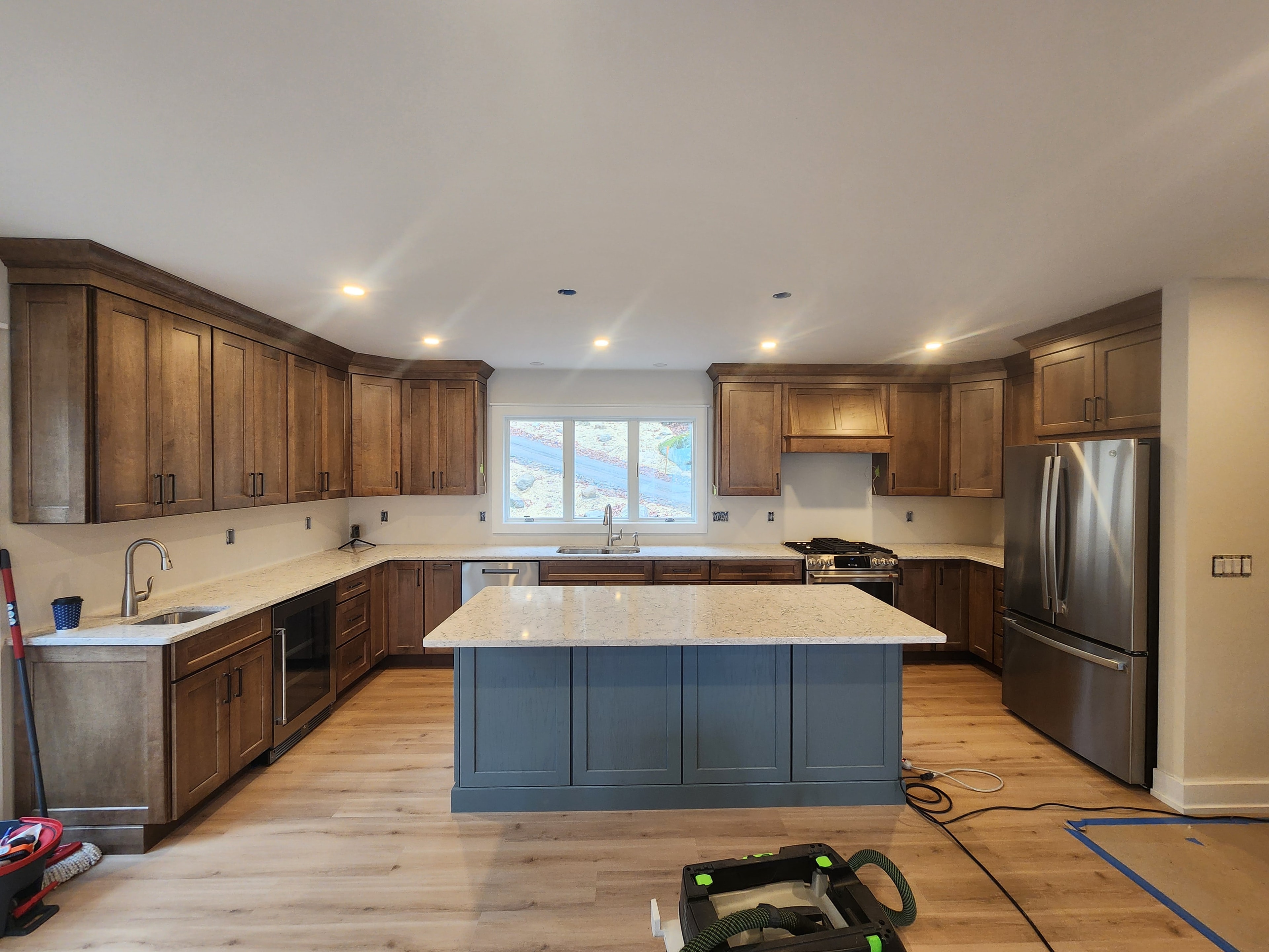 New construction kitchen with walnut shaker cabinets, blue island, granite countertops, and stainless appliances
